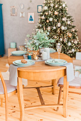 Fototapeta na wymiar Christmas table, wood chair, a glass of champagne, table setting