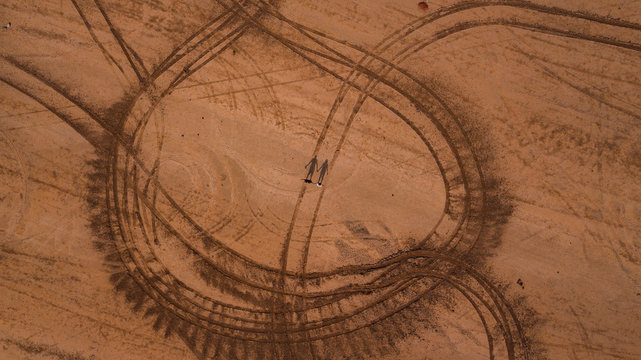 couple in the center of a desert landscape