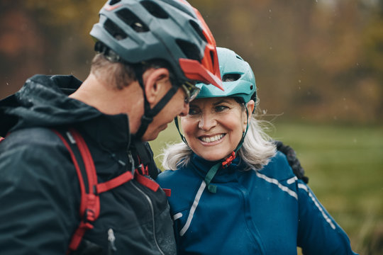 Mature couple smiling after a mountain bike ride together