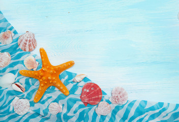 Fototapeta na wymiar Sea background with blue wood, starfish, shells