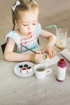 Girl drawing on macrons
