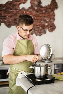 Man stirring soup