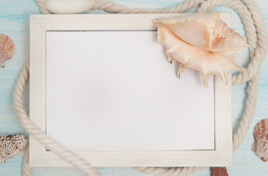 Sea background with frame and blue painted wood, rope, starfish, shells