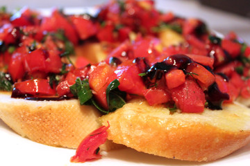 Traditional Italian sandwich Bruschetta with with tomato, olive oil, balsamic vinegar and herbs close up
