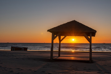 Silhouete the cabin on the sea beach in beautiful sunset