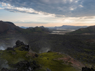 Lava field landscape in Landmannalaugar with and geothermal fumarole, river delta and Rhyolit mountain at Sunrise in Fjallabak Nature Reserve, Highlands Iceland