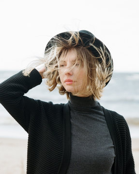 Casual woman with flying hair on seashore