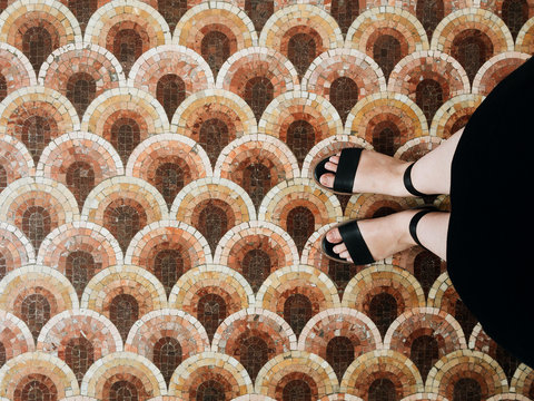 First perspective of woman's legs on tile