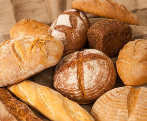 Several types of bread on burlap background