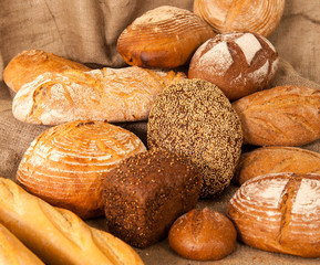 Several types of bread on burlap background