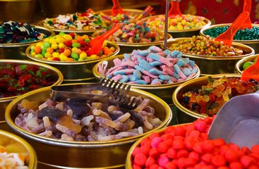 Close up of bowls full with sweet jelly candies variety on French market - St. Tropez, France