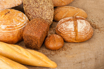 Several types of bread on burlap background