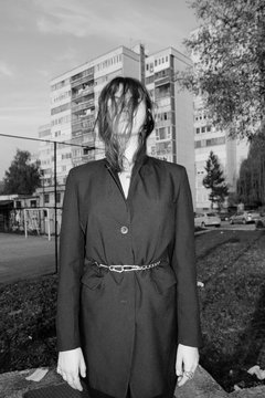 Young woman in gothic fashion style posing in urban part of city.