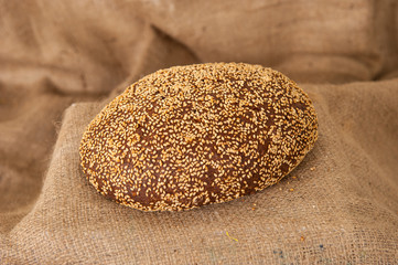 rye black bread on burlap background