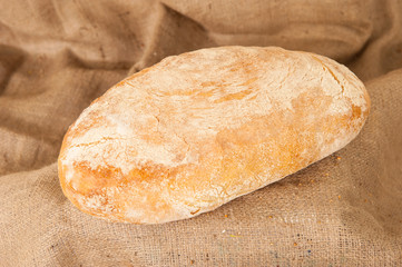 white bread on burlap background