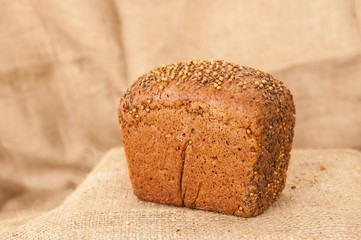 rye black bread on burlap background