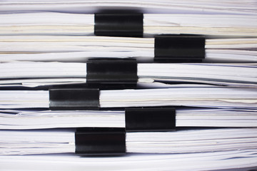 Paper clip foldel. Document pile on office desk.