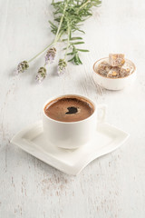 A cup of Turkish coffee and delight on a wooden table