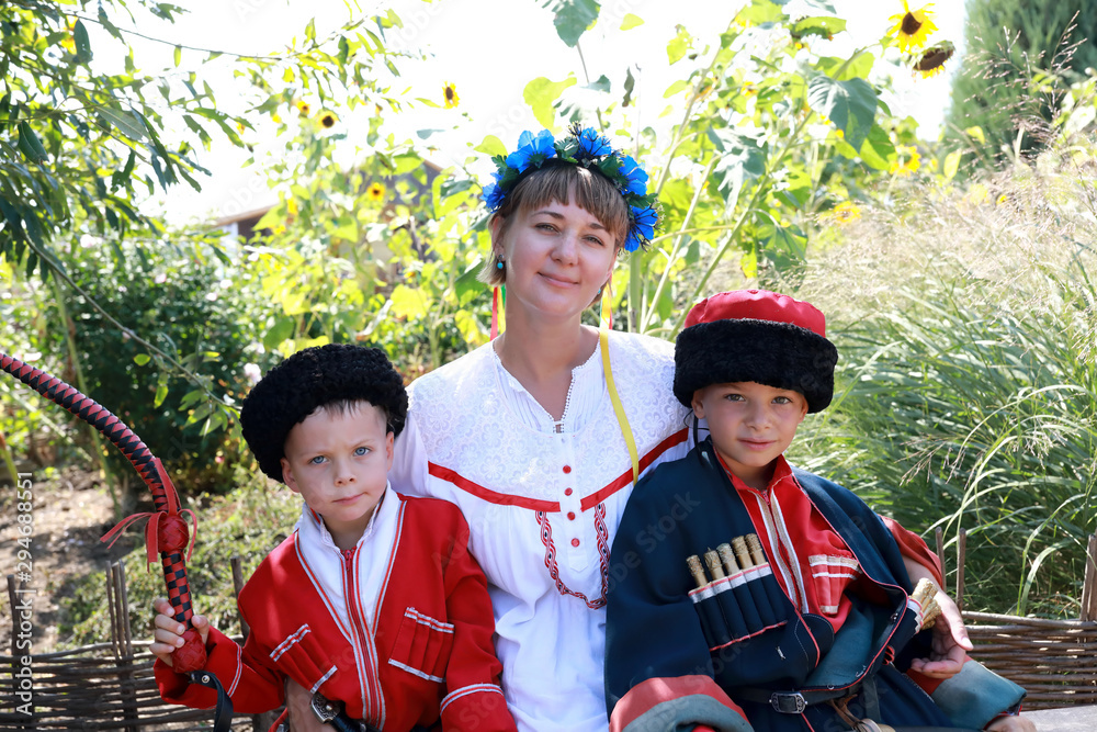 Wall mural Mother and sons in Cossack costumes