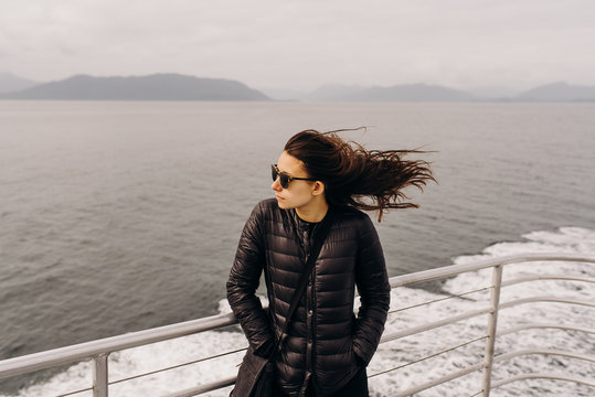 Happy young woman with the wind blowing in her hair