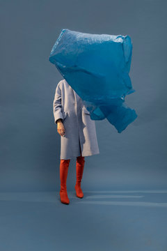model with blue coat on blue background