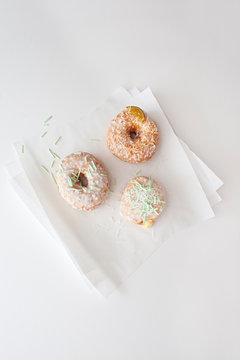 3 glazed doughnuts with sprinkles