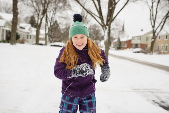 Playful Red Haired girl in the Snow