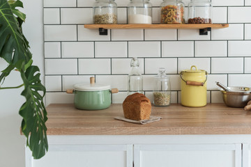 Modern kitchen with flower and shelves with products