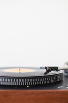 Close up of record player against white wall with copyspace