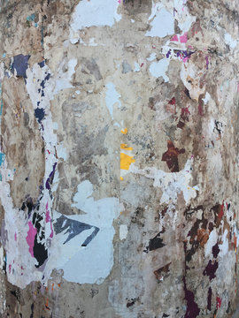 torn posters on old wall