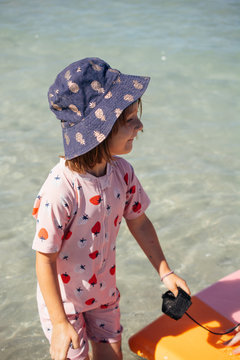Child playing learning to swim with body board