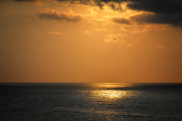 Naklejka na ściany i meble Beautiful gold sunset over the sea
