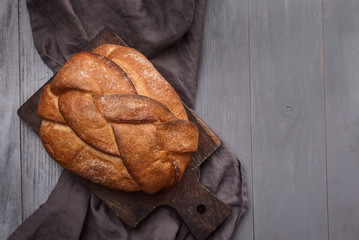 dark bread and gray linen napkin on cutting board on the table