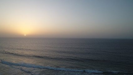 Naklejka na ściany i meble landscape and sunset on the Atlantic coast watching the breaking of the waves