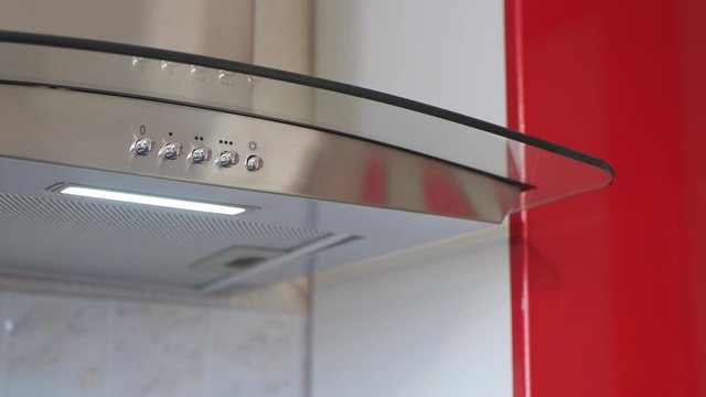 The Man Turning On The Lights On The Kitchen Hood.