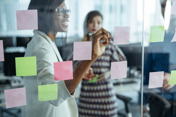 Businesspeople Looking at Glass Board