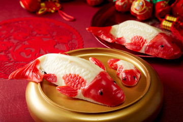 Chinese traditional food Koi rice cake ,on the table in a festive New Year atmosphere