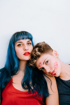 a couple of lesbians in bed leave lipstick marks on their faces