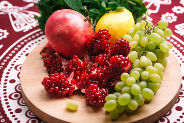 Assorted fresh fruits on a colorful oriental background top view