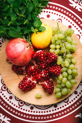 Assorted fresh fruits on a colorful oriental background top view