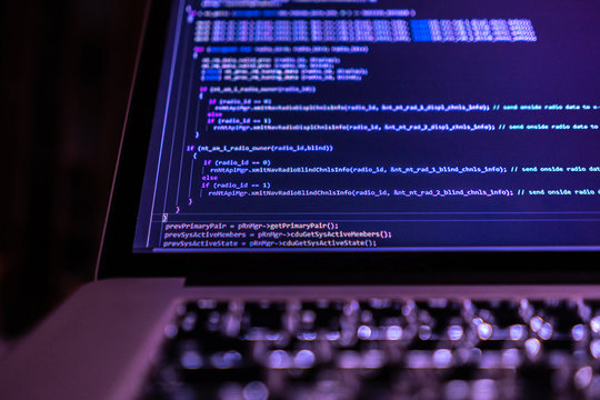 close up laptop computer screen with programming code creating