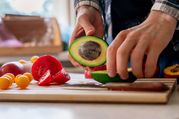 cook hand cutting the fruits and vegetables rich of vitamins