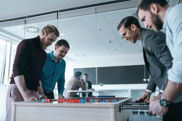 Group of Businessmen Playing Table Football