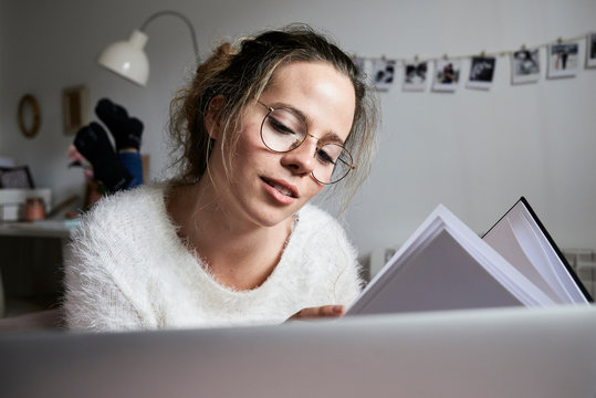 Blonde student lying on bed.
