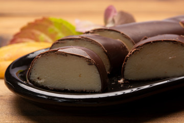 Dutch chocolate candy filled with white marzipan  in autumn colors on dark wooden background