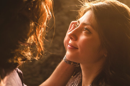 Man holding face of young woman