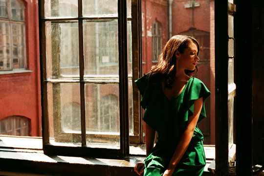 Woman Sitting By The Window In Old Building