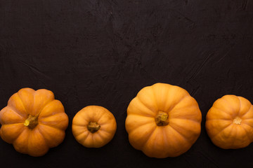 Pumpkins on black table. Halloween background