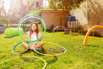Beautiful girl portrait with hoops on playground © Sergey Novikov