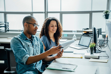 Coworkers with note pad in office